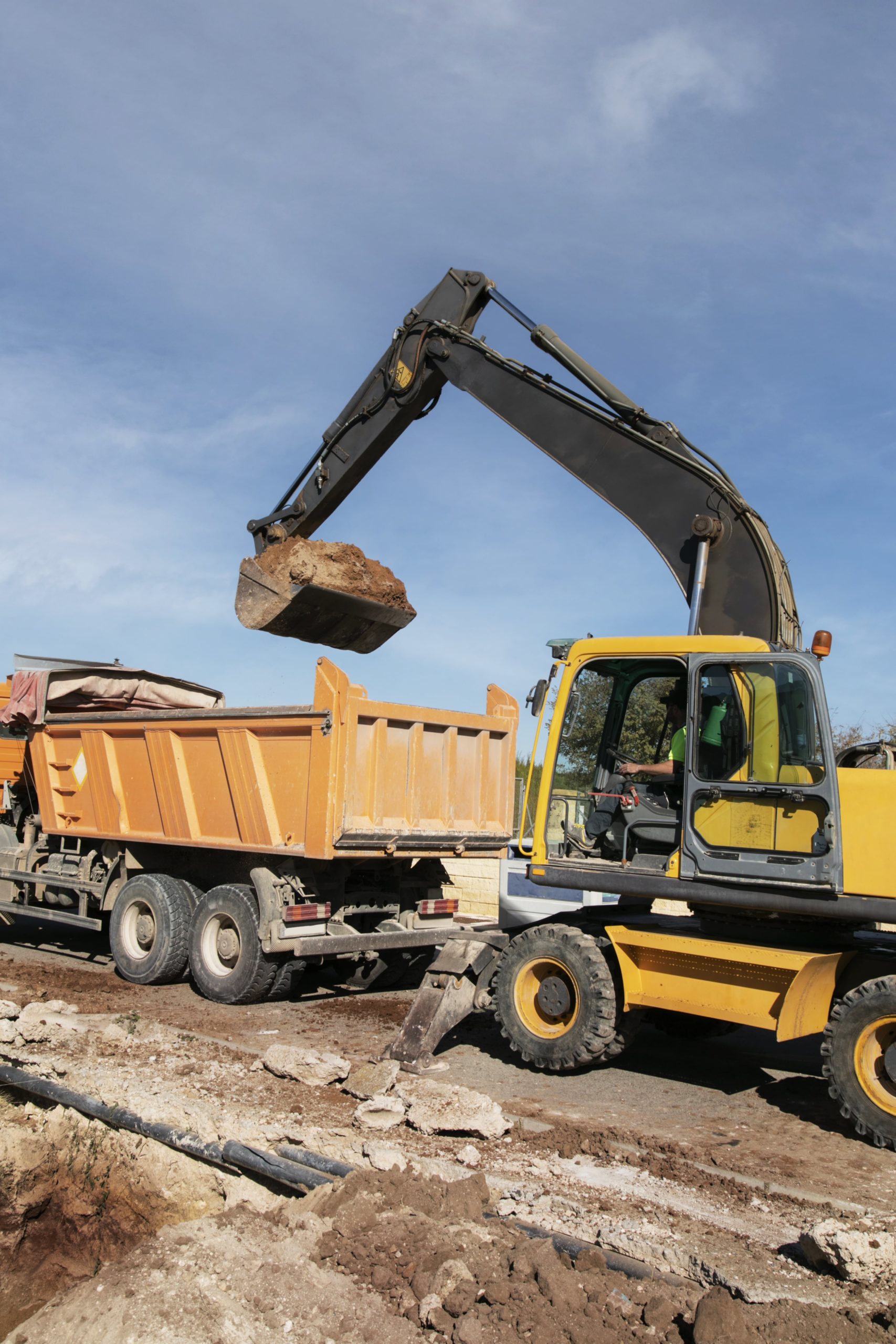 excavator-digging-ground-day-light-min